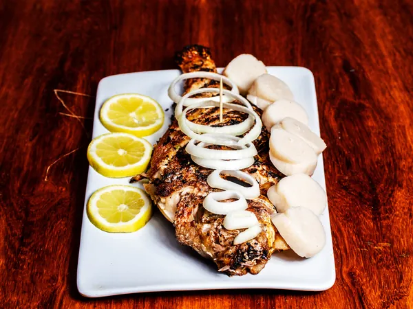 Fried Mabundu with lemon, onion rings and cassava