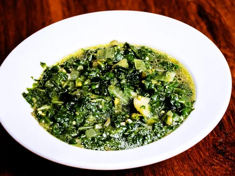 Green leaf vegetables in a white bowl
