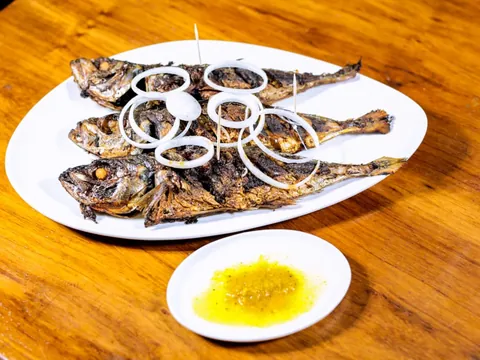 Grilled Thomson fish with onion rings and a yellow dipping sauce