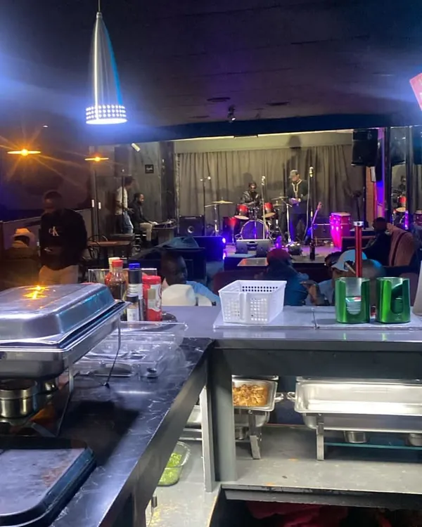 The bar and food counter at Kamalo City, with a band playing on the stage behind